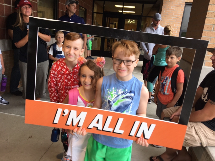 people holding a frame sign